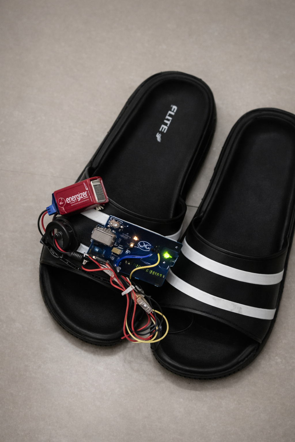 Smart Shoe prototype with Arduino, ultrasonic sensor, buzzer and 9V battery mounted on a slipper